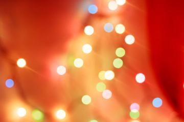 New Year's bokeh. New Year. Bokeh from the lights of a garland. The lights are on. Festive mood. Abstraction and background.