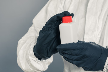 A medical scientist or a policeman wearing protective clothing holds a plastic tube in his hand. The concept of health and crime