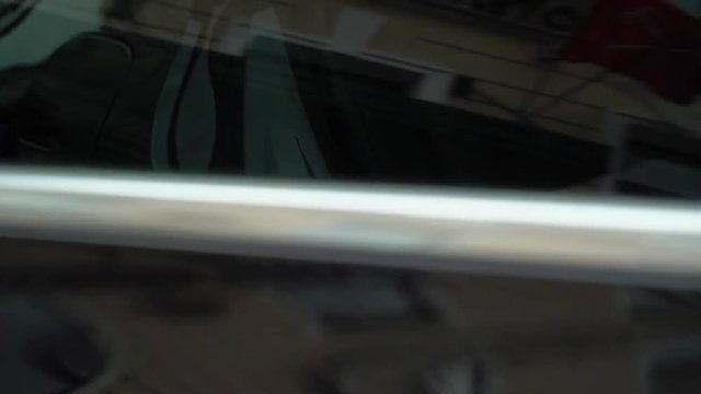 Caucasian man pening and closing car door. Luxury black car outdoors