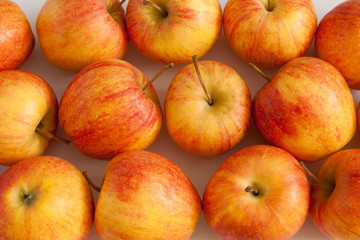 Red and yellow apples on white background.