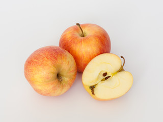 Red and yellow apples on white background. One cut in half. Isolated.