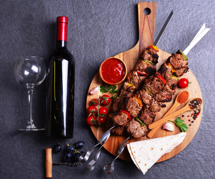Wine and kebab with spices and vegetables