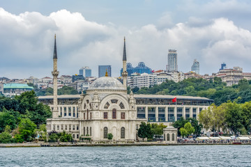 Fototapeta na wymiar Dolmabahce Mosque (Aka Bezmi Alem Valide Sultan Mosque) and modern skyscraper, Istanbul, Turkey.