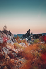 Mystic Rock towers at colorful sunset light in the countryside. Sandstone rock formation Teufelsmauer (Devil's Wall) in Blankenburg, National park Harz in Germany, Harz Mountains.