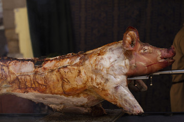 Pig on a rotisserie grill