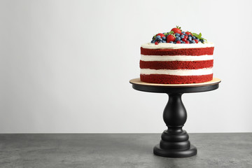 Delicious homemade red velvet cake and space for text on light background