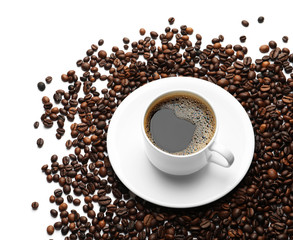 Roasted coffee beans and cup of hot beverage on white background