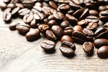 Roasted coffee beans on wooden background, closeup