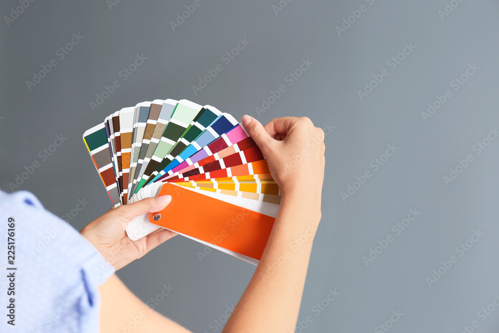 Canvas Prints Female interior designer with palette samples on color background, closeup. Space for text