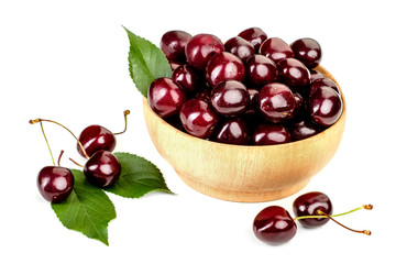 ripe juicy cherry berries with leaves in a plate