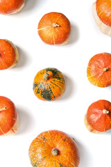 Flat lay composition with orange pumpkins on white background. Autumn holidays