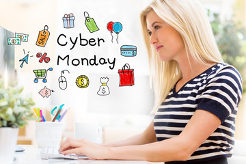 Cyber Monday with happy young woman sitting at her desk in front of the computer
