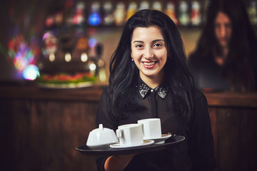 Waiters carrying plates with food, in a restaurant.