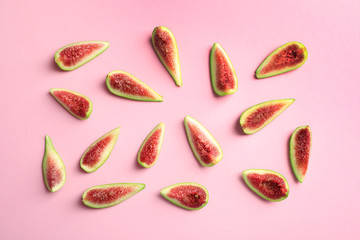 Fresh ripe fig slices on color background, top view