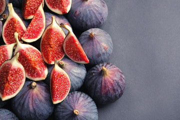 Fresh ripe figs on gray background, top view. Space for text