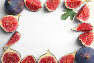 Flat lay composition with fresh ripe fig slices on white background. Space for text