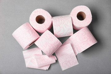 Fototapeta na wymiar Rolls of toilet paper on grey background, top view. Personal hygiene