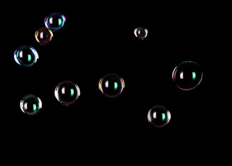 Beautiful translucent soap bubbles on dark background
