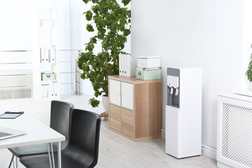 Modern water cooler in stylish office interior