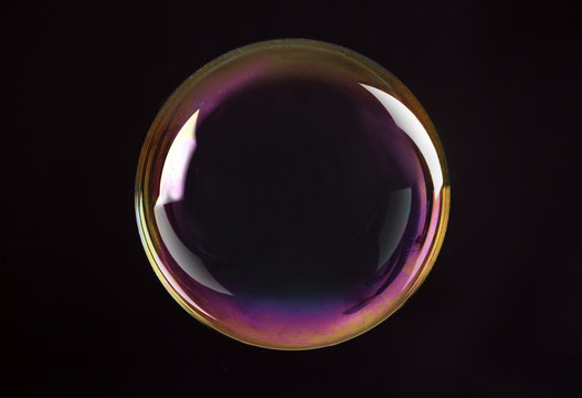 Beautiful translucent soap bubble on dark background