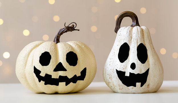 Halloween pumpkins on a shiny light background