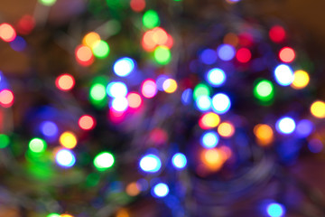 Blurred background of burning Christmas lights. Christmas and New year holidays concept
