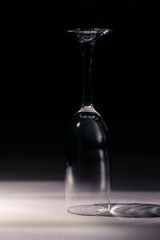 empty champagne glass, standing upside down, in the dim light