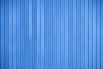 Blue fence made of smooth vertical boards
