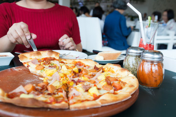 Woman hands taking slices of Pizza