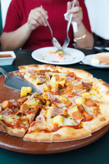 Woman hands taking slices of Pizza