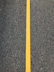 Fototapeta premium yellow line on road,Surface rough of asphalt