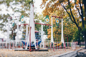 Fototapeta na wymiar Empty swings in park