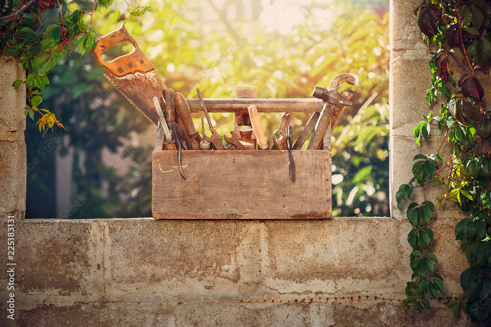 Wall mural vintage toolbox at the yard at sunset