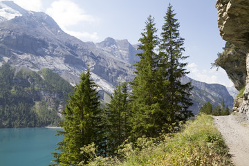 Amazing tourquise Oeschinnensee with waterfalls and Swiss Alps, Kandersteg, Berner Oberland, Switzerland.