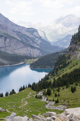 Fototapeta na wymiar Amazing tourquise Oeschinnensee with waterfalls and Swiss Alps, Kandersteg, Berner Oberland, Switzerland.