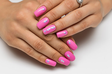 summer pink manicure with triangles, crystals, silver on short square nails on a white background
