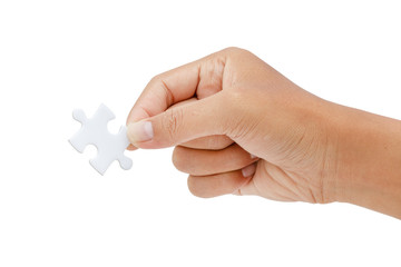 hand trying to connect jigsaw puzzle piece isolated on white background - clipping paths