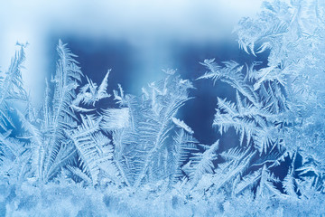 Close up view of a frosty pattern on the glass window. Abstract, background