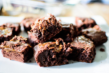 Decadent rich Chocolate dessert brownies on tray conceptual dark chocolate temptation with caramel