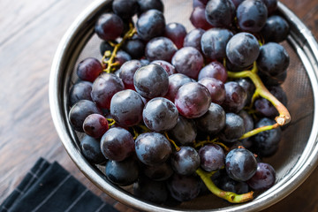 Fototapeta premium Bunch of Red Grapes in Metal Colander.