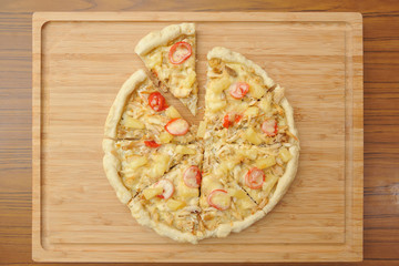 Appetizing cut pizza on a wooden cutting board