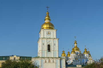 Fototapeta na wymiar Golden domes of St. Michael Cathedral in Kiev, Ukraine. St. Michael's Golden-Domed Monastery - famous church complex in Kiev, Ukraine