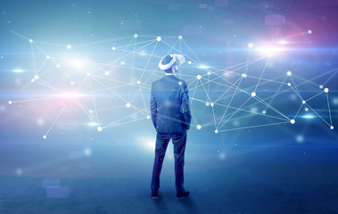 Young businessman standing with vj glasses and checking life-sized connectivity project
