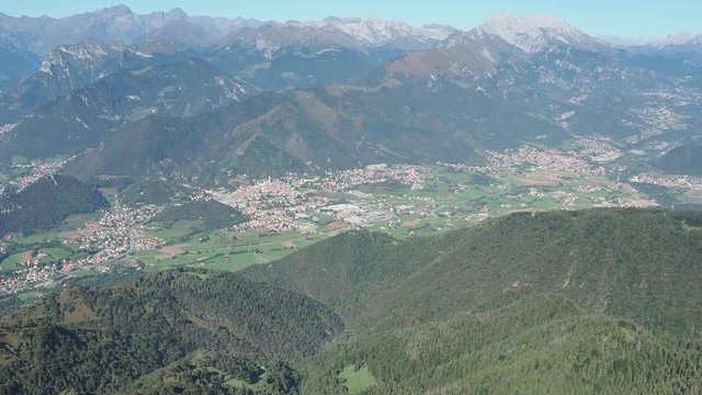 4K Drone aerial view to the Seriana valley and Orobie Alps in a clear and blue day. View of the highest mountains. Landscape from Pizzo Formico Mountain, Bergamo, Italy