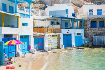 Traditional colorful fishing houses near the beach in Firopotamos village in Milos island, Cyclades, Greece