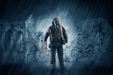 Hazard, menace man in a ruined crumbly building with arms on his hand
