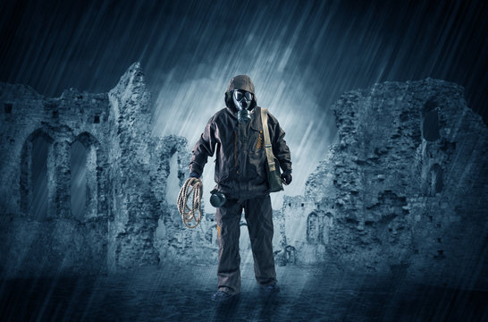 Hazard, menace man in a ruined crumbly building with arms on his hand
