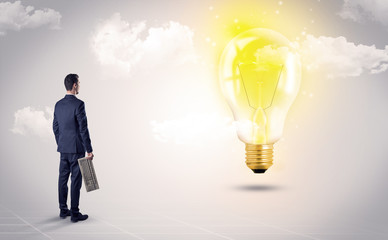 Obraz premium Businessman standing with his back with objects in his hand and looking at the globe, courtesy of NASA 