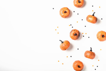 Decorative pumpkins and confetti for Halloween top view. Flat lay.
