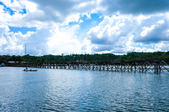 Uttanunan Bridge The bridge is the longest wooden bridge in Thailand,Top Travel Thailand,A wooden bridge crosses the river.